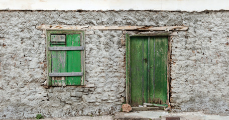 Weathered green painted door and window, background.