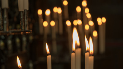 background of a candle burning in a church.
