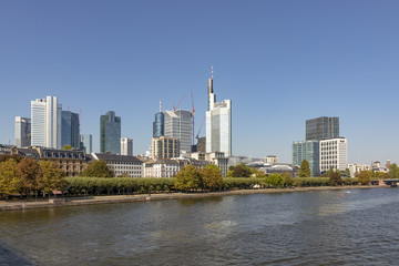 Fototapeta na wymiar skyline of Frankfurt in early morning with illuminated skyscraper with river view
