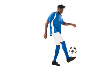 side view of athletic african american sportsman playing with soccer ball isolated on white