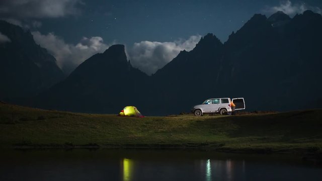 Camping at night with car.