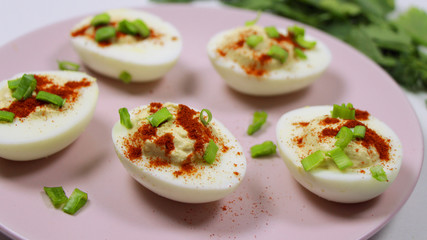 Healthy Deviled Eggs as an Appetizer with Paprika and Green Onion