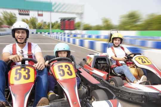 Happy Family Driving Go Kart On The Track