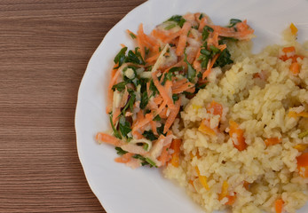Rice with vegetables on a white plate.