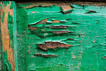 An ancient background in the form of a wooden texture with a shabby weathered paint of different colors. Vintage coating on boards of different sizes. Broken sharp wood.
