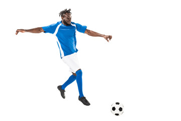 full length view of athletic african american soccer player hitting ball isolated on white