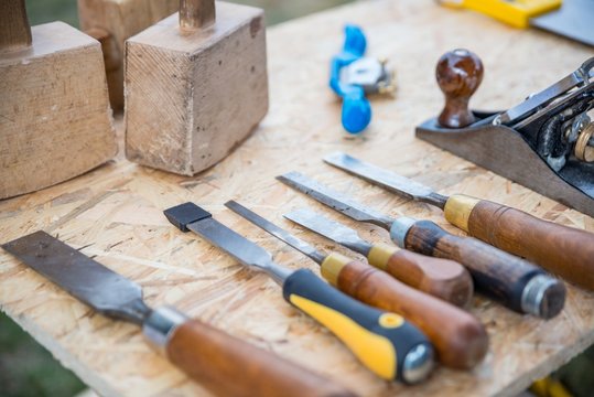 Chisels and other carpenter’s tools on table.
