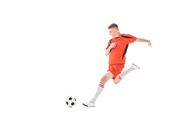 Obraz premium full length view of young sportsman playing soccer isolated on white