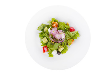 Greek salad with feta, olives, lettuce, red onion, cucumber, tomato, bell pepper, pesto on plate, white isolated background, view from above, for the menu, restaurant bar cafe