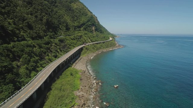 Aerial view of Patapat viaduct in the coast of Pagudpud, Ilocos Norte. Highway with bridge by coast sea near the mountains. Philippines, Luzon.