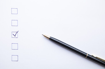 Pen and Checklist on white paper. Business concept