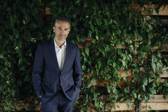 Portrait of confident businessman in green office