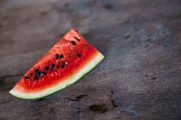 Fototapeta na wymiar fresh ripe slices of watermelon on a darl wooden background with copy space