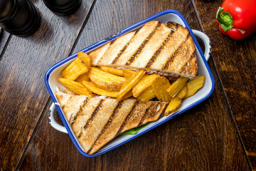 club sandwich with meat and French fries