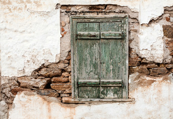 Old wooden door on grunge weathered wall.