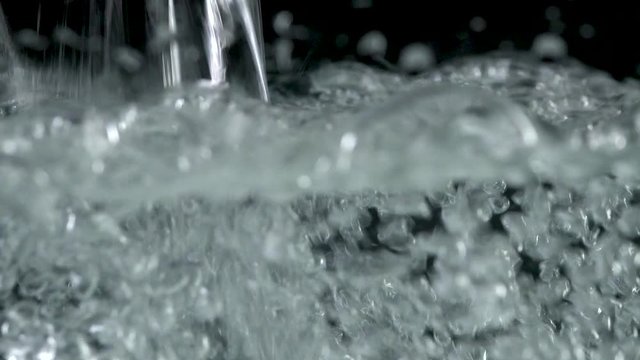 Bubbles rising to the surface on black backgrounds. Slow motion