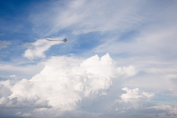 kite and Cumulus clouds and sun in the sky