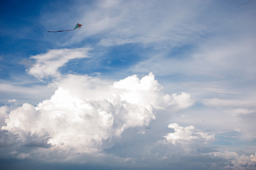 kite and Cumulus clouds and sun in the sky