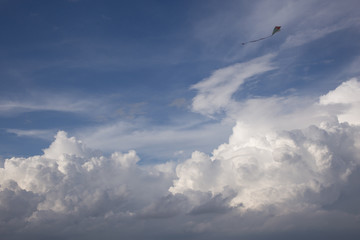kite and Cumulus clouds and sun in the sky