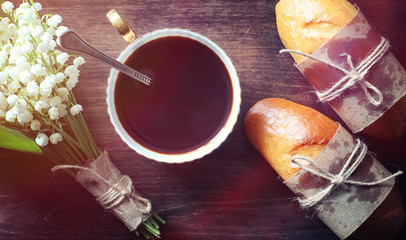 Fresh rolls for breakfast. Bun with butter to a cup of coffee in