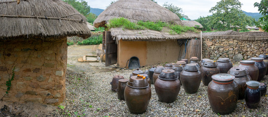 Vases of kimchi were lefted outside the house. Kimchi is a traditional and national food of Korean...