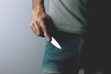 gangster threatens with a knife