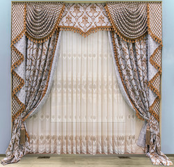 Elegant curtains in a classic, palace style. Semi-transparent tulle with floral ornament. Combined,  two-sided curtains with a lambrequin and a jabot