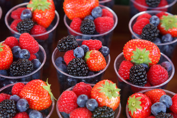 set of different berries in glasses