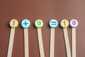 mathematics Toy Numbers on Brown Background.
