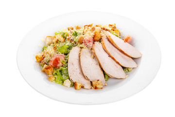 Caesar salad with slices of chicken breast, rusks, tomato, lettuce, cheese on plate, white isolated background Side view. For the menu, restaurant, bar, cafe