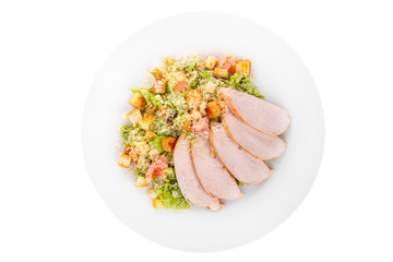 Caesar salad with slices of chicken breast, rusks, tomato, lettuce, cheese on plate, white isolated background, view from above, for the menu, restaurant, bar, cafe
