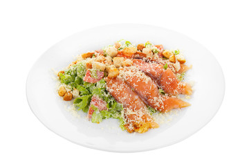 Caesar salad with fish lobes, salmon, trout, biscuits, tomato, lettuce, cheese on plate, white isolated background Side view. For the menu, restaurant bar cafe