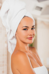 young smiling woman relaxing with towel on head