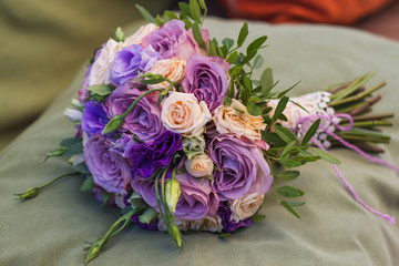 wedding bouquet on a green cushion, bouquet of bride from rose cream spray, rose bush, rose purple Memory Lane, violet eustoma, eucalyptus