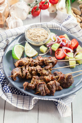 Traditional pork satay with peanut sauce and vegetables