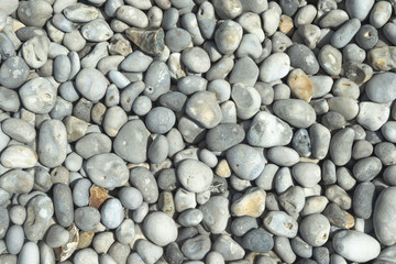 All rounded tiny pebbles from beach, a natural summer background, smooth polished pebble stones