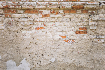 Old damaged brick wall background. Horizontal color photo.