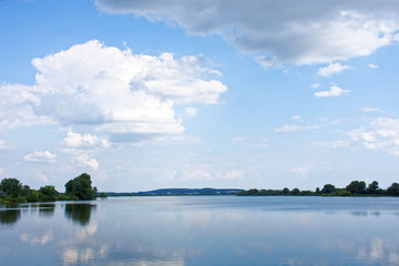 clouds float over the river