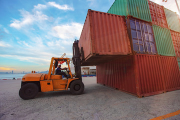 container unit being handling lifting by forklift to transfer from yard to the ship in port terminal © ID_Anuphon