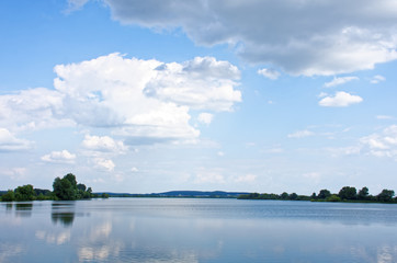 clouds float over the river