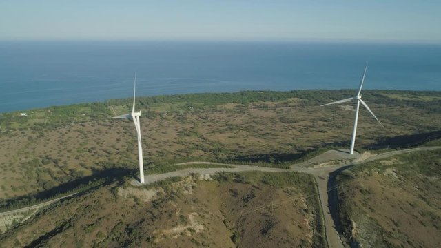 Aerial view of Windmills for electric power production on the seashore. Bangui Windmills in Ilocos Norte, Philippines. Ecological landscape: Windmills, sea in Pagudpud.
