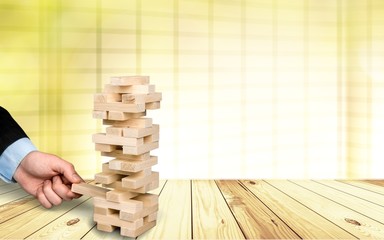 Wood blocks stack game with Hand on