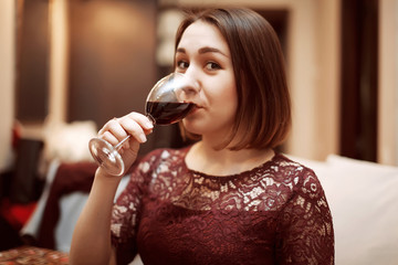 Plakat Portrait of a gorgeous young brunette woman having wine fun.