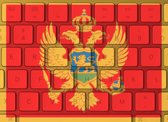 Montenegro flag and computer keyboard in the background