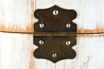 Old rustic hinge on box with white scratched paint / Hinge background 