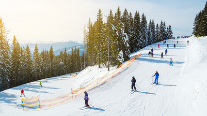 Winter holidays in the mountains. Mountain-skiing resort in the Carpathians.several skiers on a...
