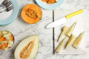 Flat lay composition with cut fresh tasty melons on table