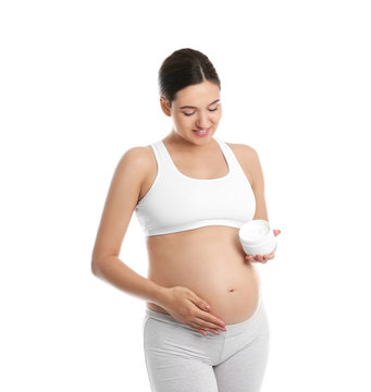 Pregnant woman holding body cream on white background