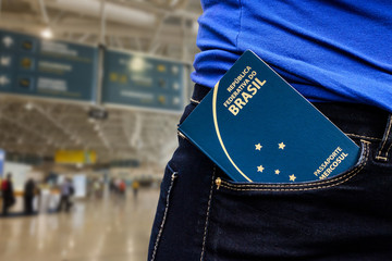 close up in Brazilian passport in a trouser bag with euro banknotes