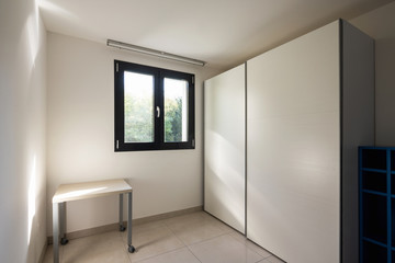 Room with window and large wardrobe
